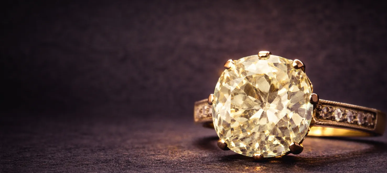 Old cut diamond solitaire ring in yellow gold, moody still life